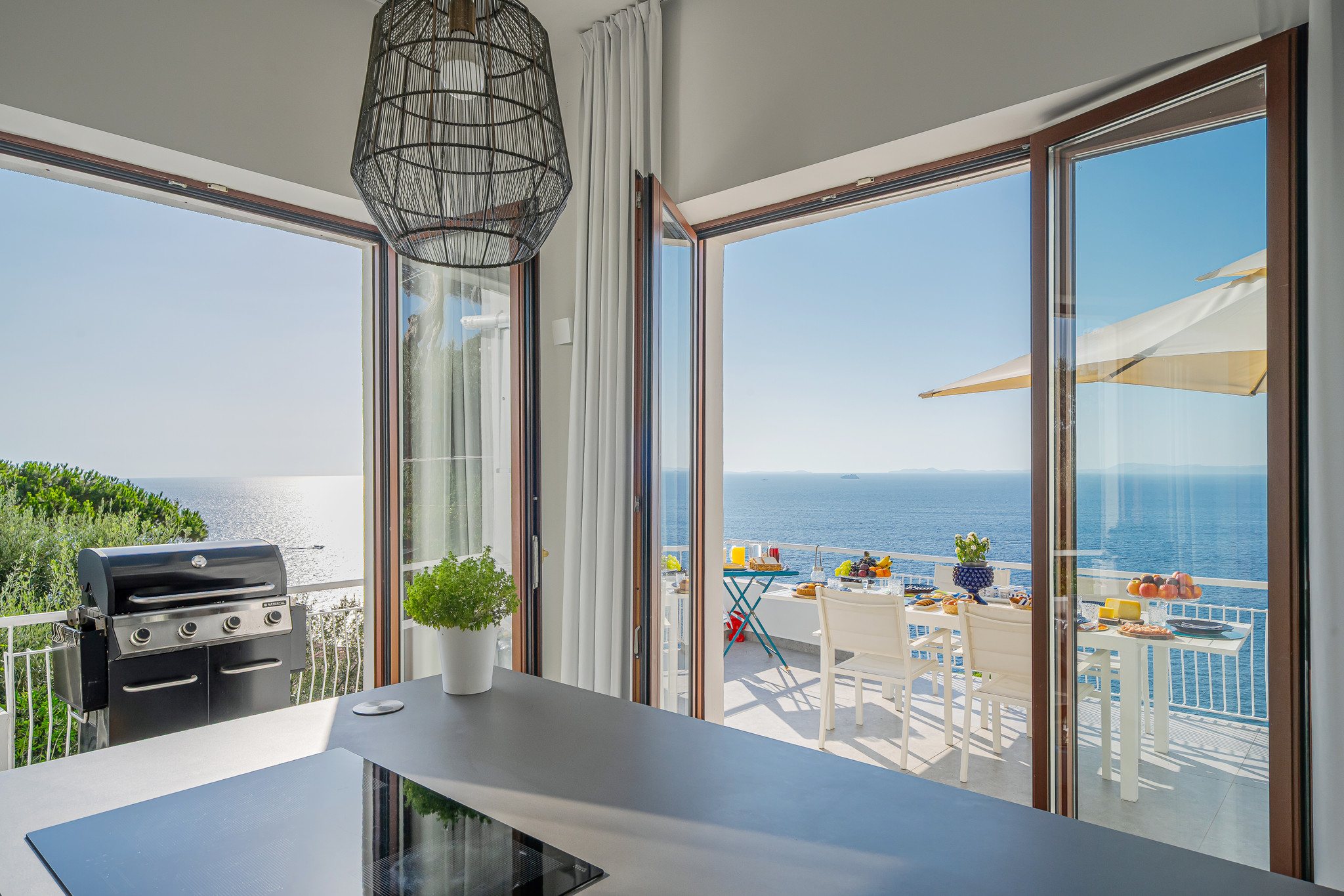 The outdoor grill area with a sea view