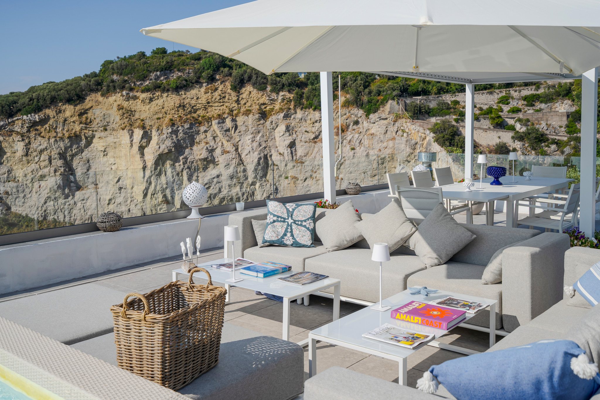 The outdoor lounge of La Balena Blu with the sea behind it