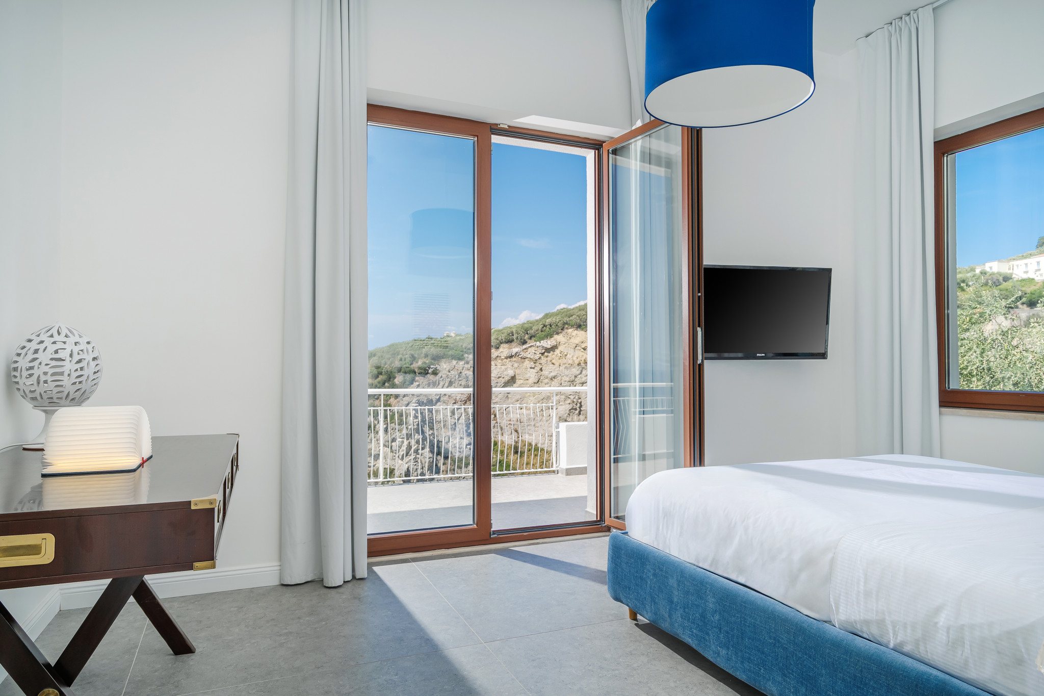 Sea-view bedroom with large windows facing the Mediterranean